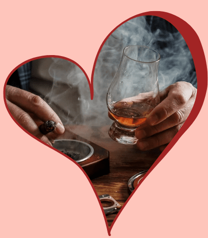 Cigar and whiskey within heart-shaped frame.